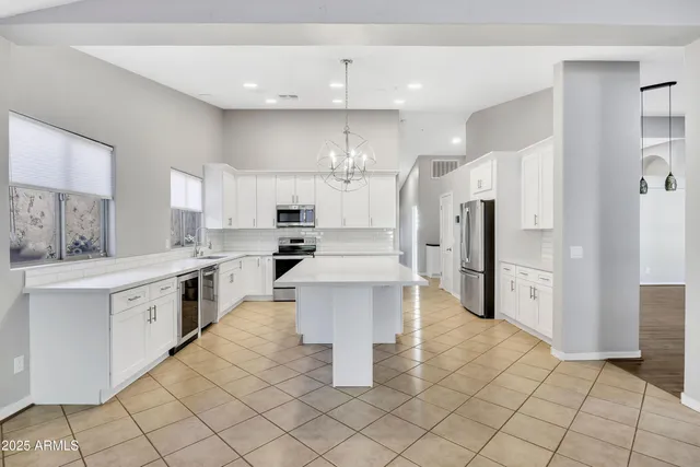 a kitchen with stainless steel appliances a refrigerator sink and cabinets