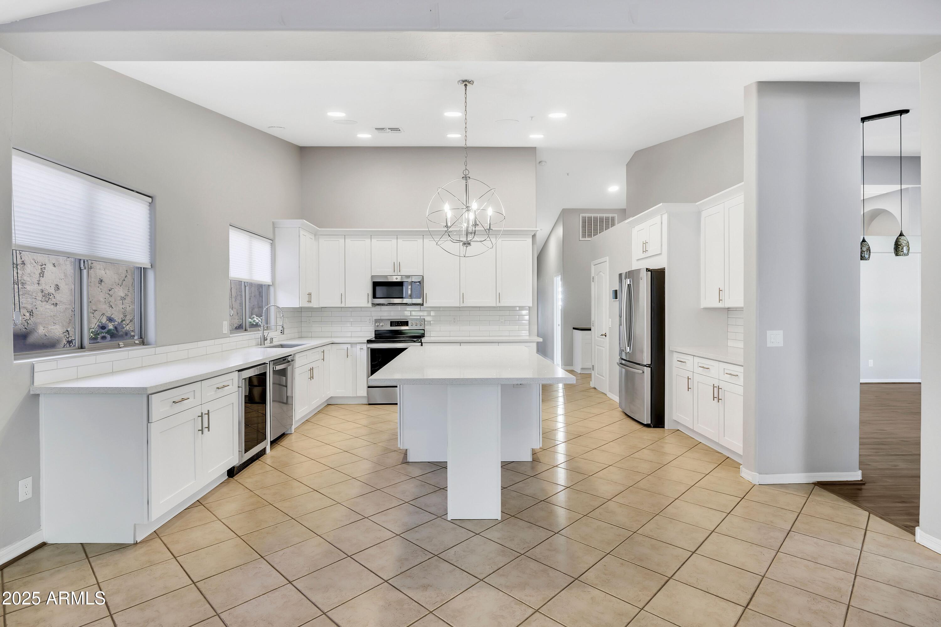 7446 East Glenn Moore Road Scottsdale, AZ 85255 - Photo 4 of 18 a kitchen with stainless steel appliances a refrigerator sink and cabinets