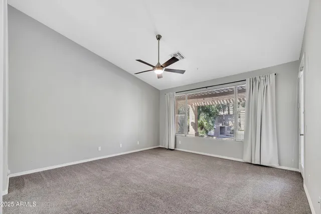 a view of room with window and ceiling fan