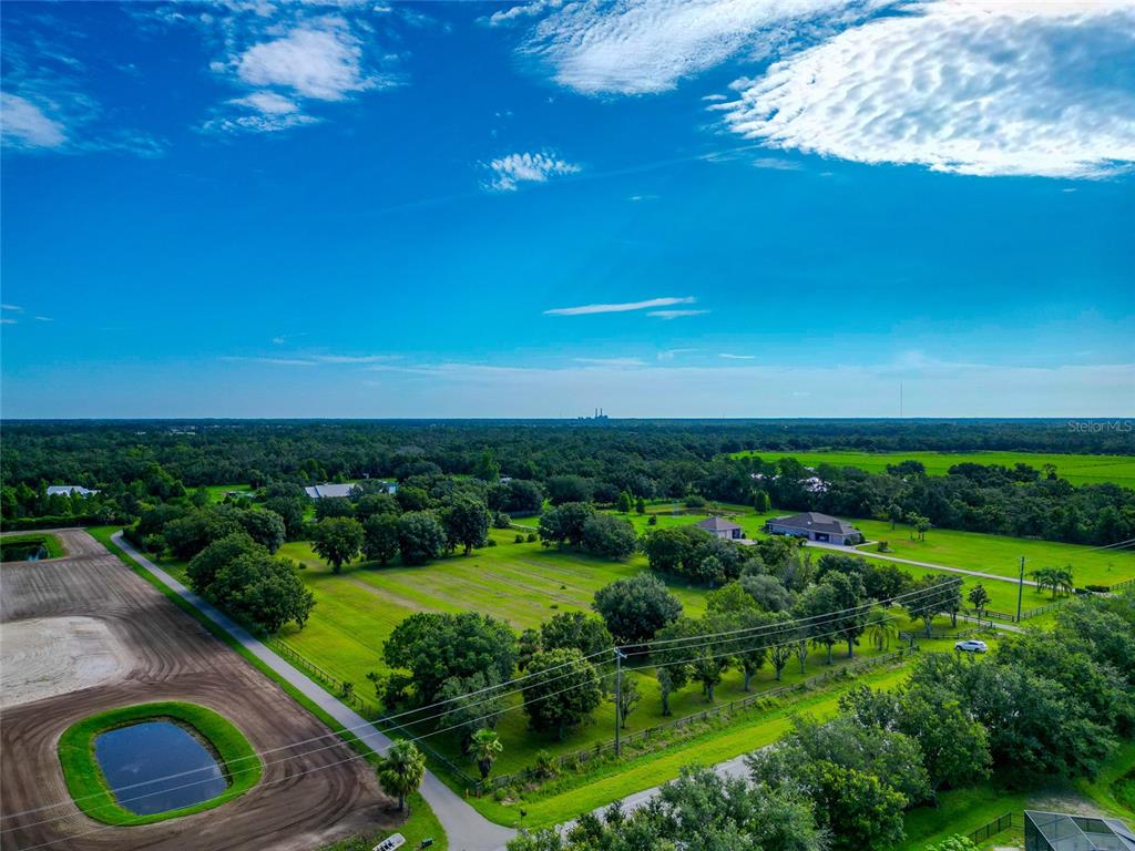 13210 Mulholland Road Parrish, FL 34219 - Photo 26 of 28 a view of a garden with a building in the background