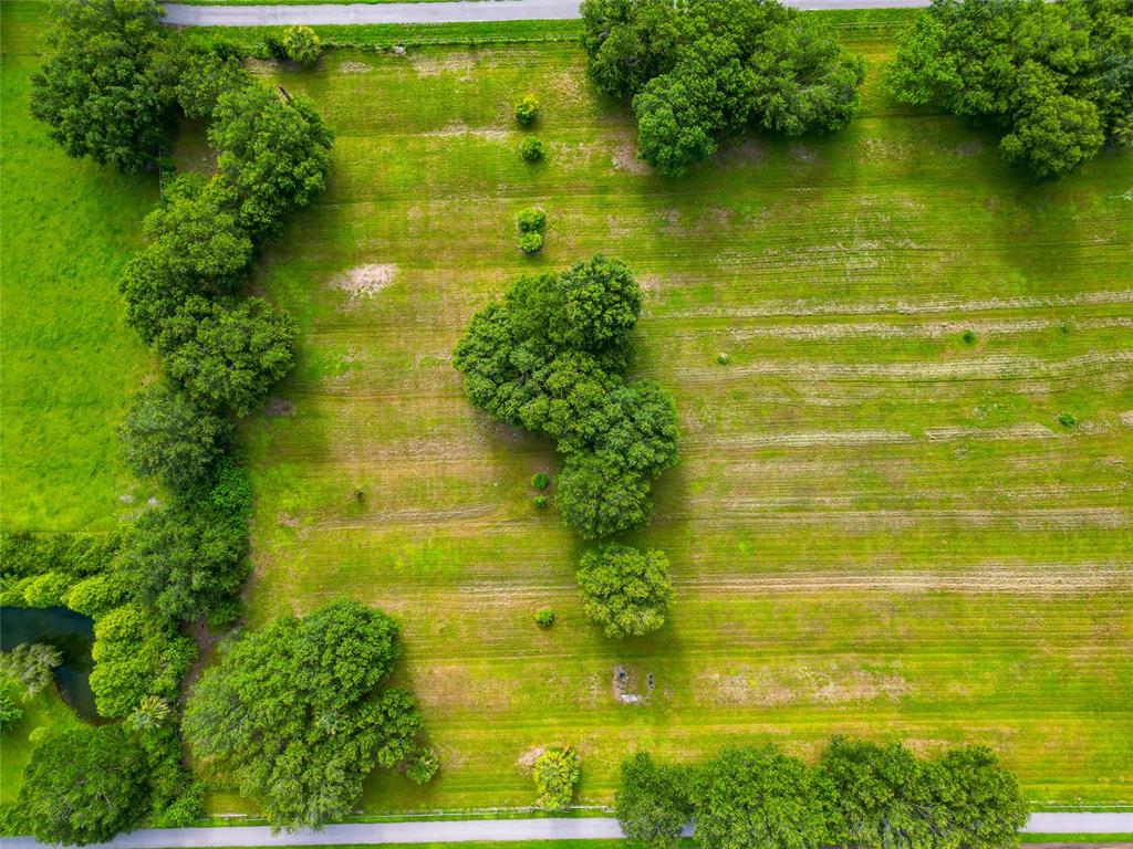 13210 Mulholland Road Parrish, FL 34219 - Photo 5 of 28 a view of a lake with a large trees