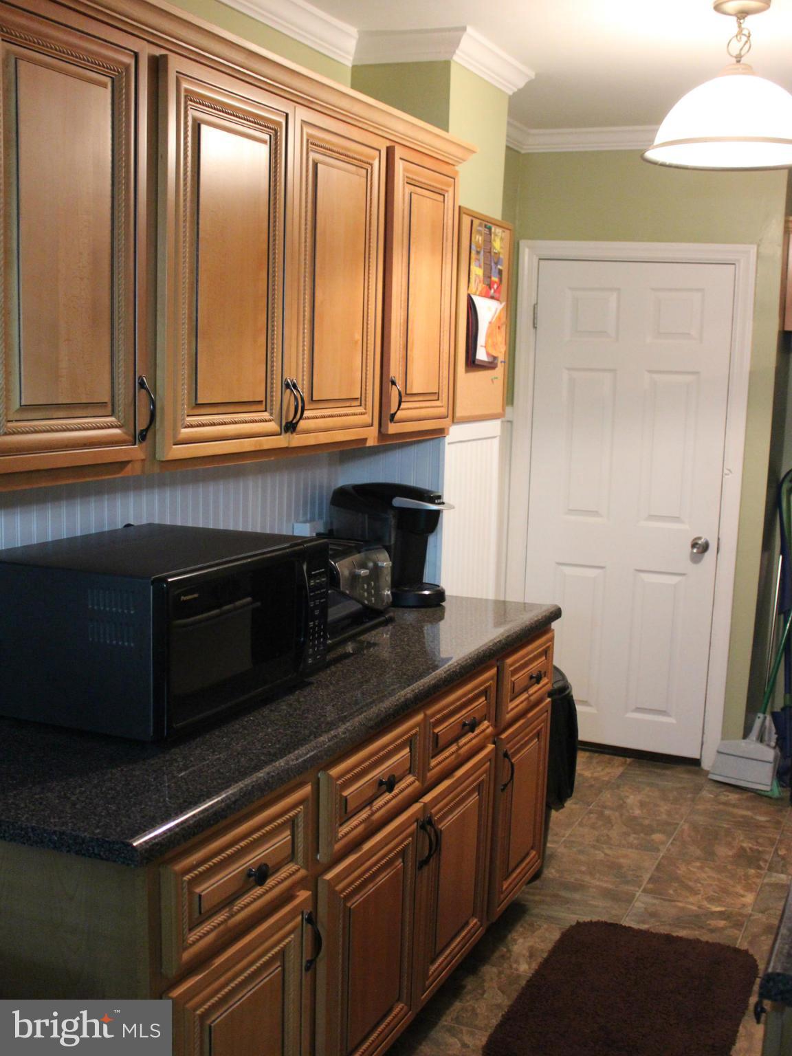 234 Arden Road West Baltimore, MD 21225 - Photo 5 of 26 a kitchen with stainless steel appliances granite countertop a stove a sink and a microwave