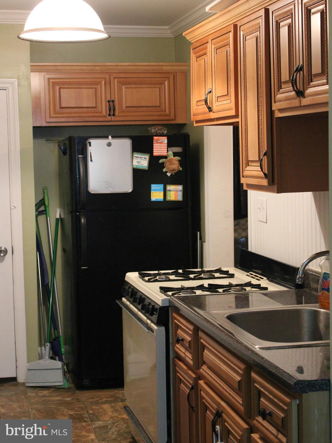 234 Arden Road West Baltimore, MD 21225 - Photo 6 of 26 a kitchen with stainless steel appliances granite countertop a refrigerator and a stove