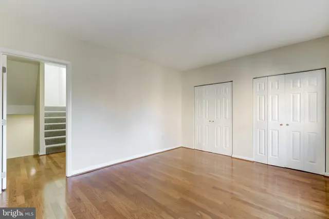 a view of empty room with wooden floor