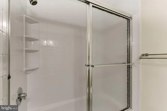 a bathroom with a glass shower door