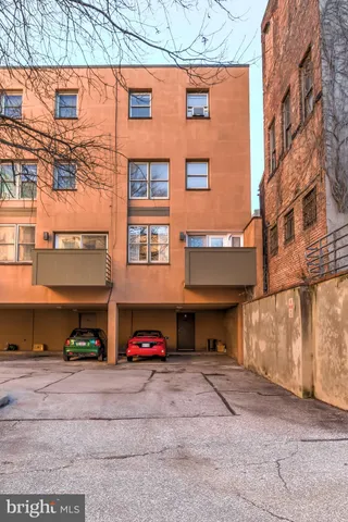 a view of a building with cars parked