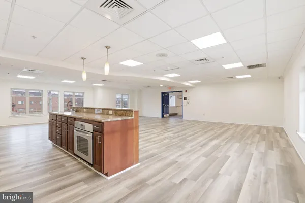 a kitchen with stainless steel appliances granite countertop a sink stove and microwave