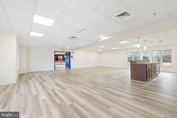 a view of an empty room and glass door