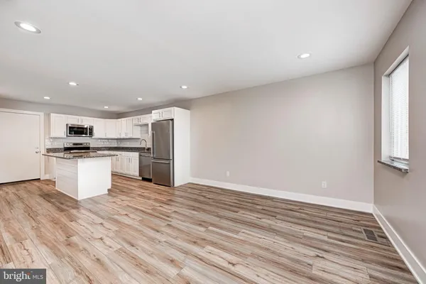 a view of a livingroom with a furniture and a kitchen