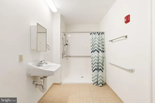 a view of a kitchen with a sink and a refrigerator