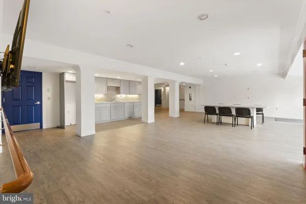 a view of a hall way with furniture and floor to ceiling window