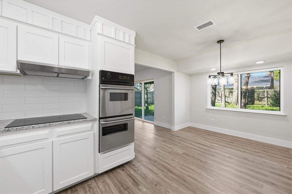 2804 Bent Tree Lane Arlington, TX 76016 - Photo 11 of 32 a kitchen with stainless steel appliances granite countertop a stove and a white cabinets