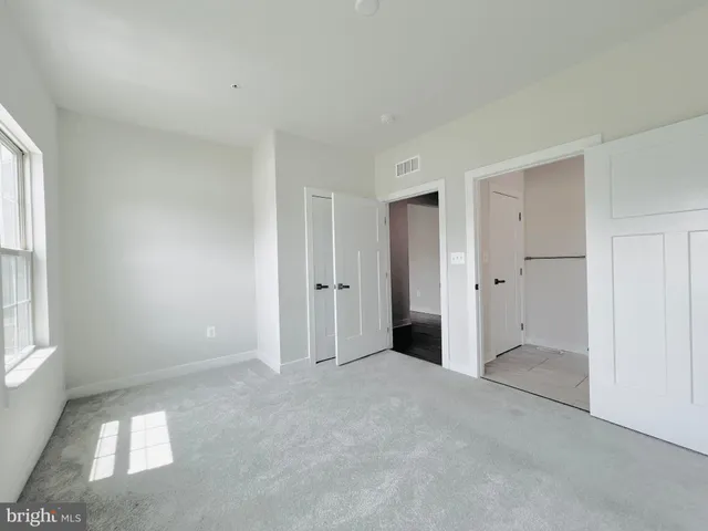 a view of an empty room and closet area