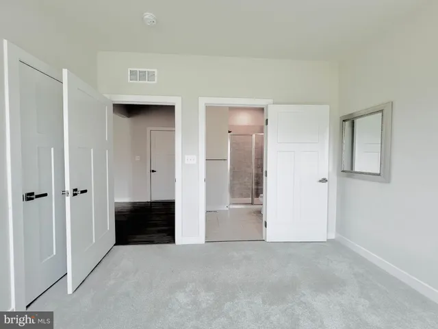 a view of empty room with a fireplace and wooden floor