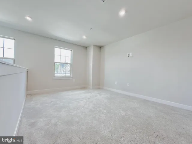 an empty room with windows and closet
