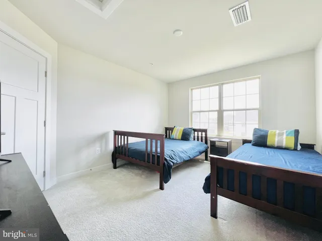 a bedroom with furniture and a flat screen tv