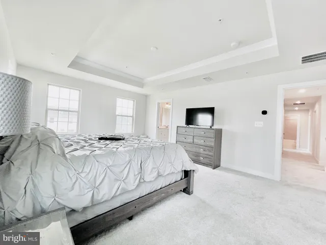 a spacious bedroom with a bed and a window