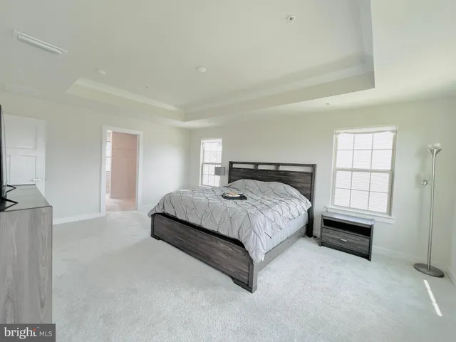 a spacious bathroom with a double vanity sink a bathtub and a window
