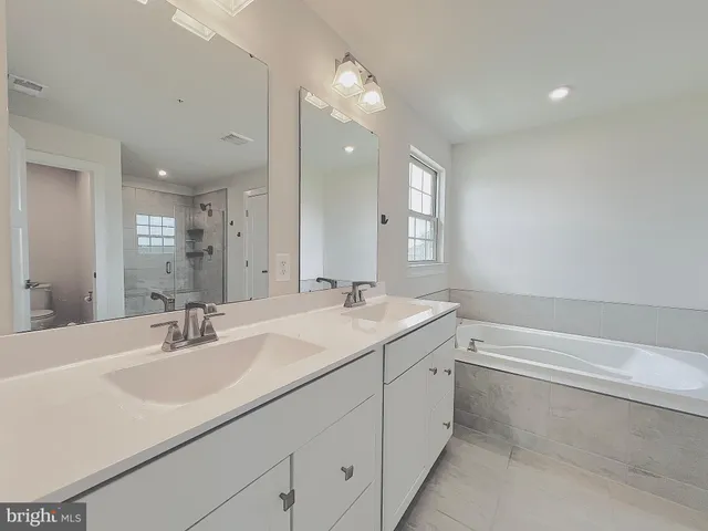 a bathroom with a bathtub and shower