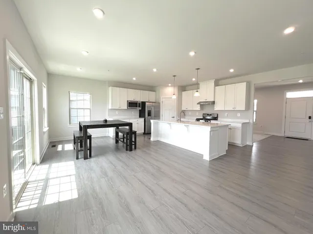 a kitchen with a table and chairs in it