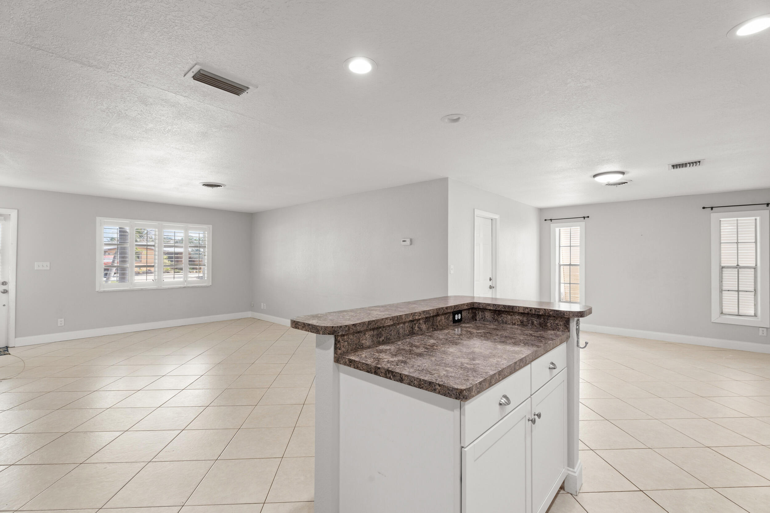 1459 Southwest Seahawk Way Palm City, FL 34990 - Photo 11 of 43 an empty room with kitchen and window