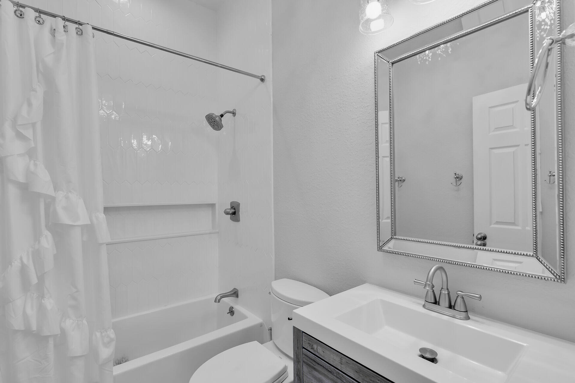 853 Ellen Drive Key Largo, FL 33037 - Photo 26 of 42 a bathroom with a granite countertop sink a toilet and shower