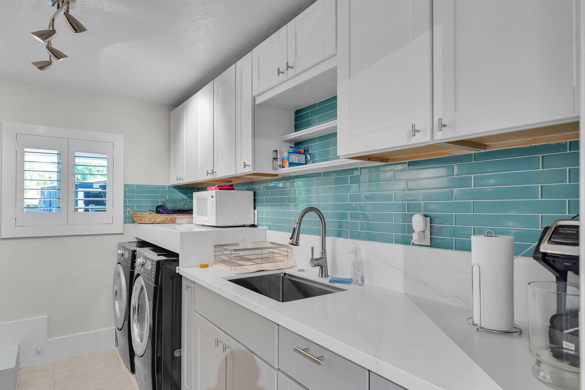 853 Ellen Drive Key Largo, FL 33037 - Photo 32 of 42 a kitchen with stainless steel appliances a sink a stove and white cabinets