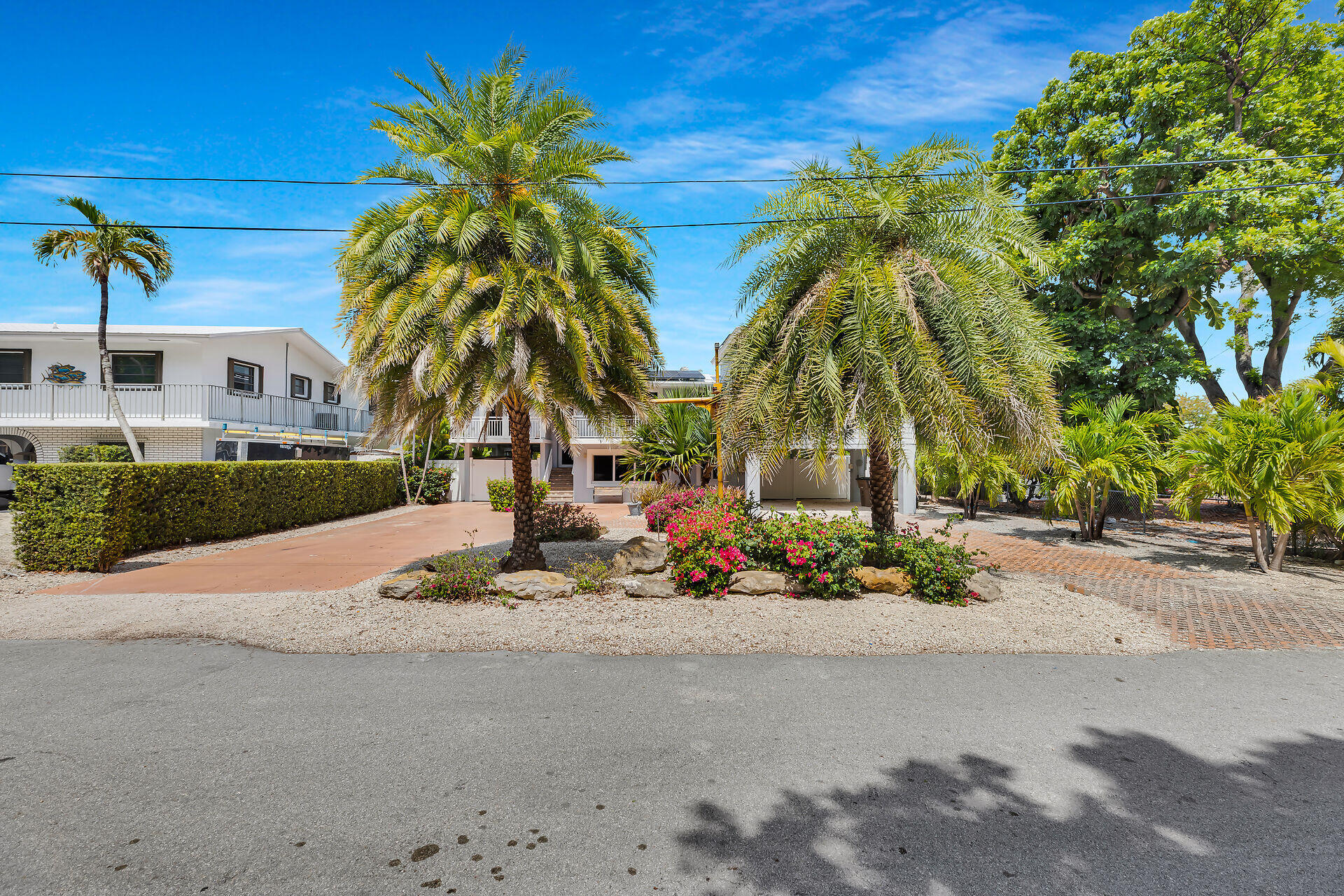 853 Ellen Drive Key Largo, FL 33037 - Photo 33 of 42 a row of palm trees and a yard in front of the house
