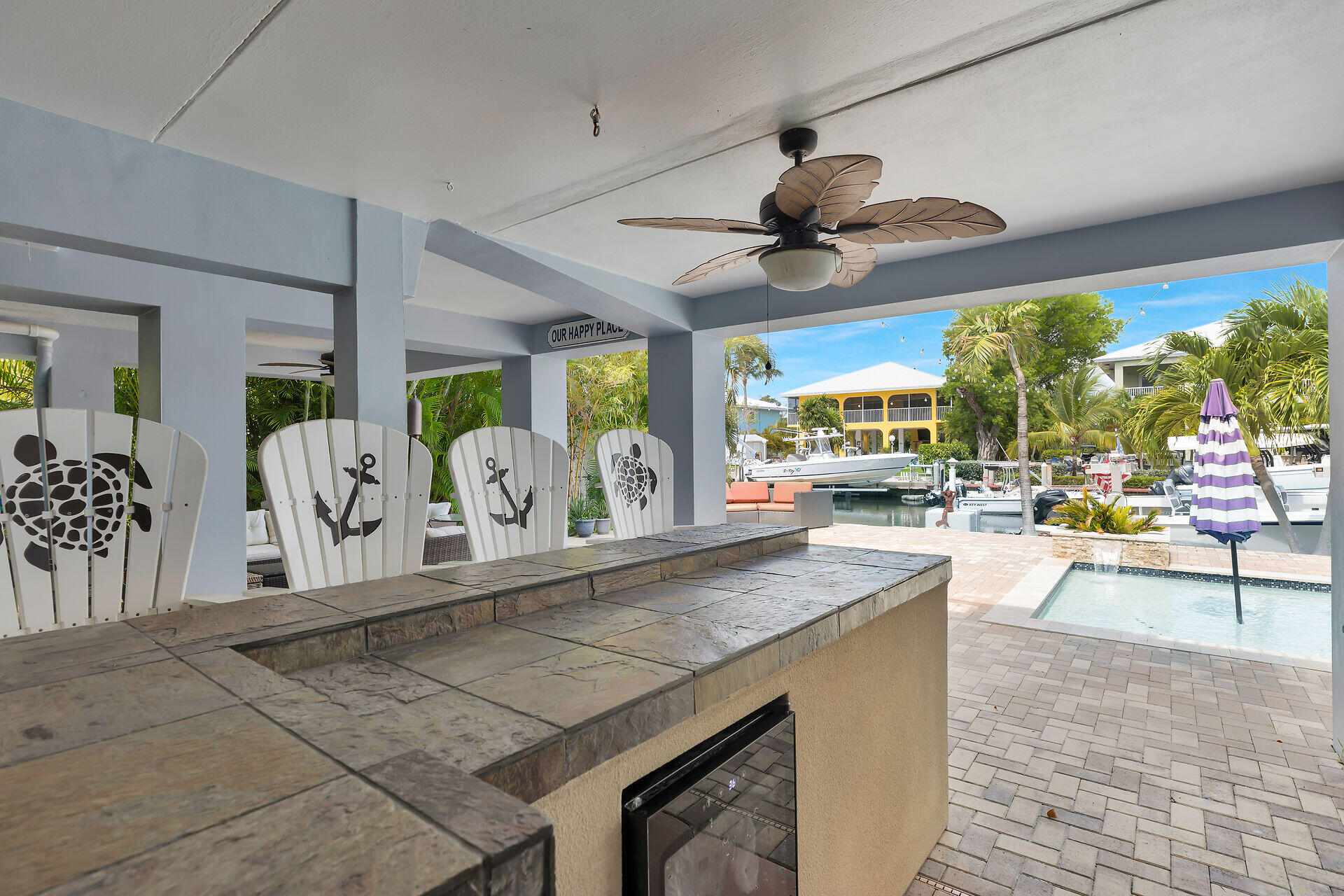 853 Ellen Drive Key Largo, FL 33037 - Photo 37 of 42 a view of a kitchen with kitchen island stainless steel appliances a table and chairs in it