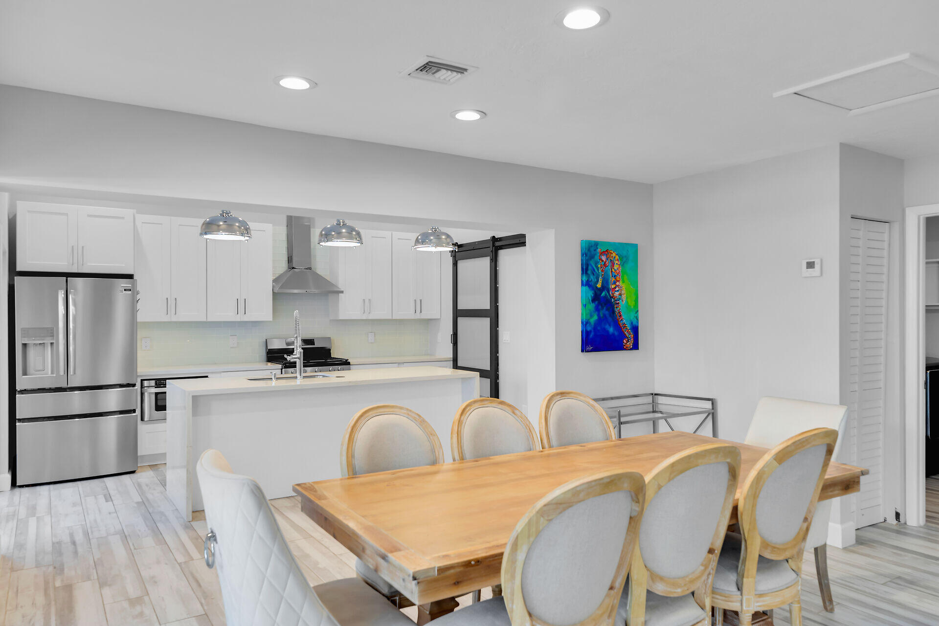 853 Ellen Drive Key Largo, FL 33037 - Photo 6 of 42 a kitchen with stainless steel appliances a table and chairs