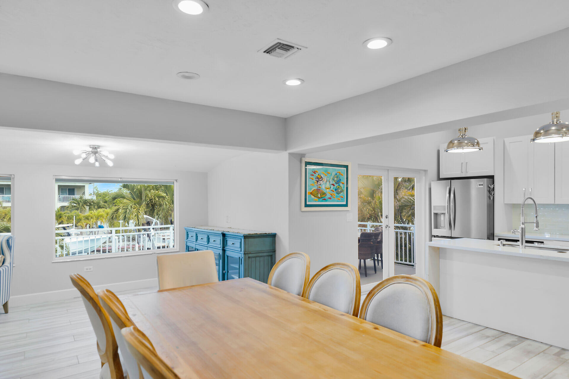 853 Ellen Drive Key Largo, FL 33037 - Photo 7 of 42 a view of a dining room with furniture a chandelier and wooden floor