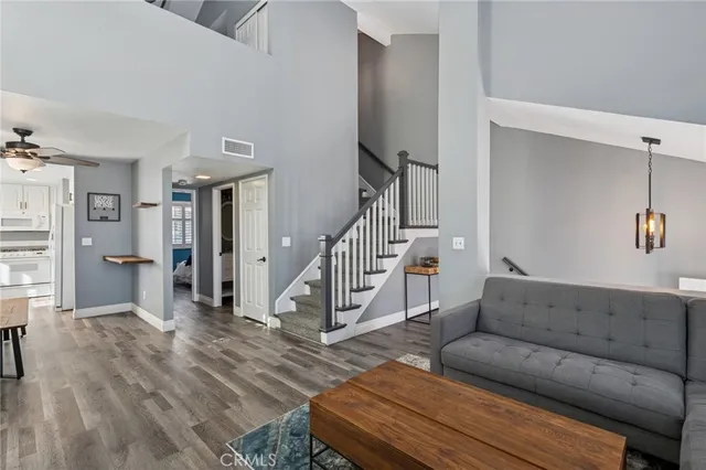 a living room with furniture and a wooden floor
