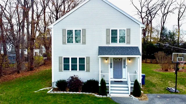 a front view of a house with a yard