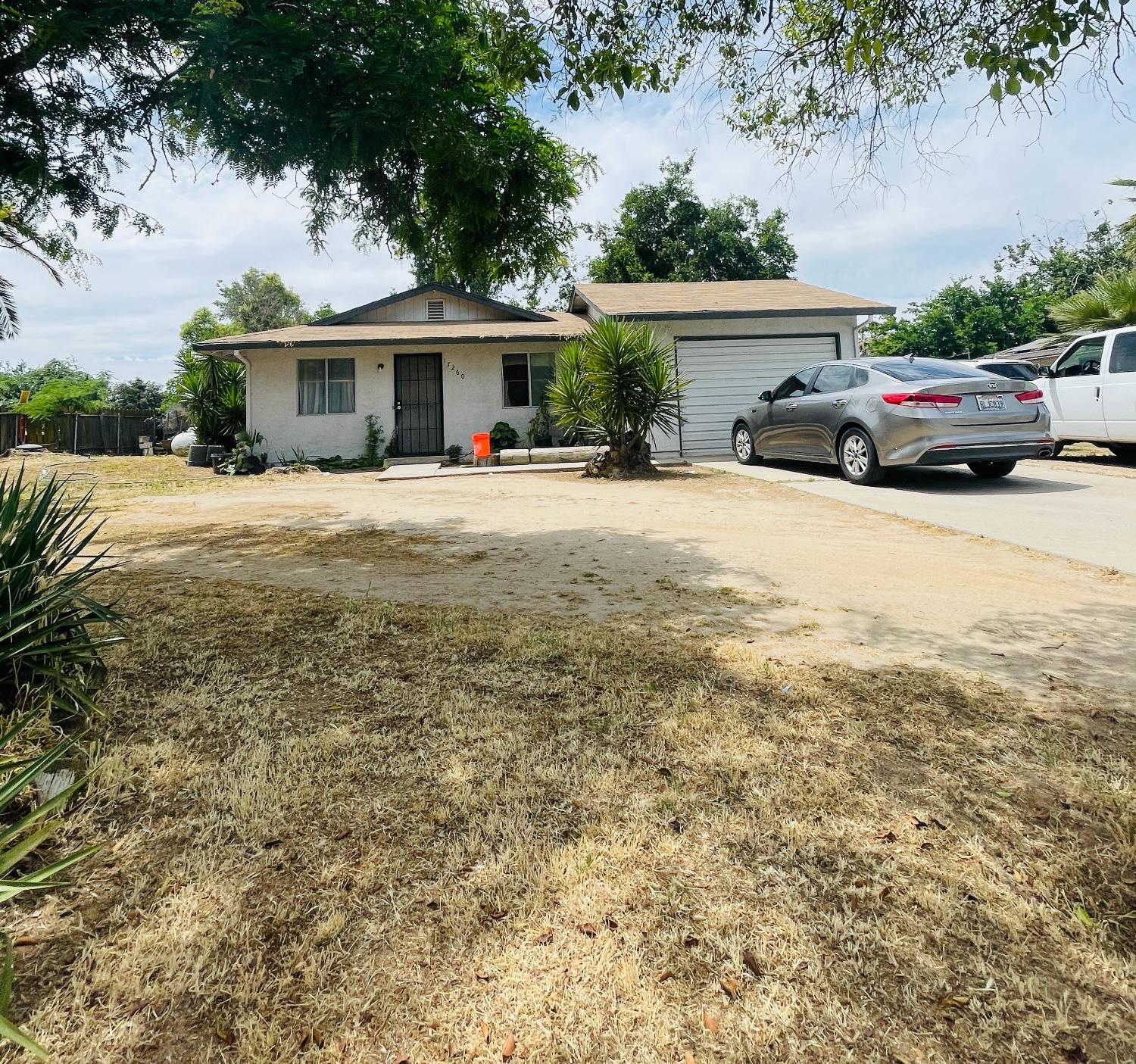17260 Rodeo Drive Madera, CA 93638 - Photo 1 of 19 a car parked in front of house with a yard