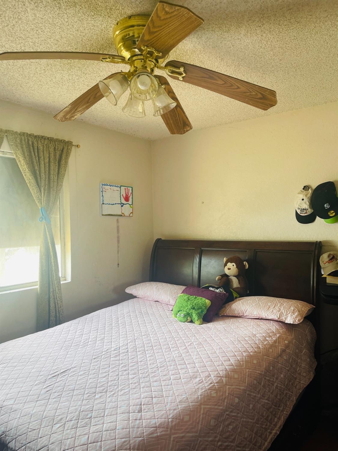 17260 Rodeo Drive Madera, CA 93638 - Photo 18 of 19 a bedroom with a bed and chandelier