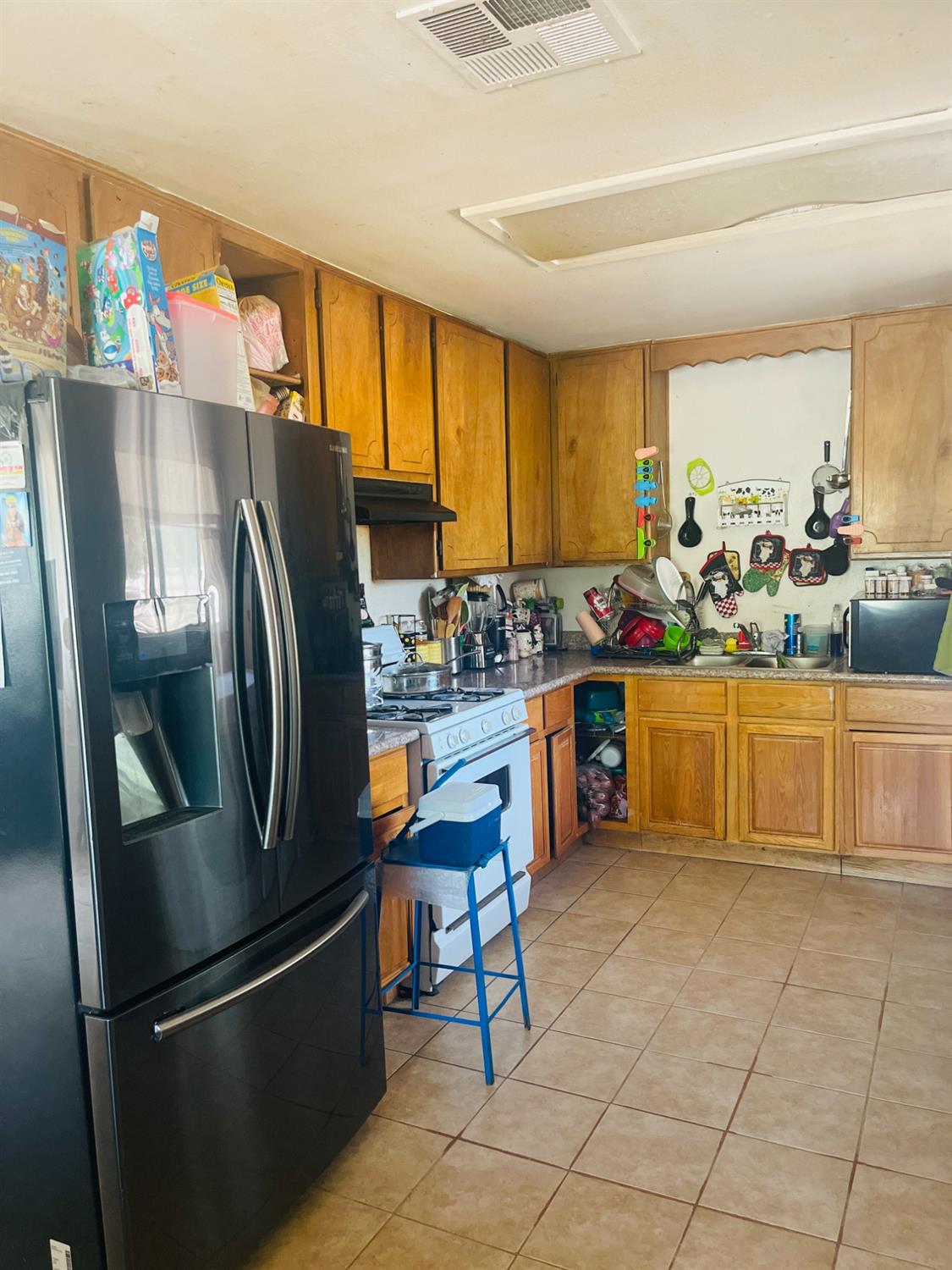 17260 Rodeo Drive Madera, CA 93638 - Photo 7 of 19 a kitchen with stainless steel appliances a refrigerator a sink a stove and cabinets