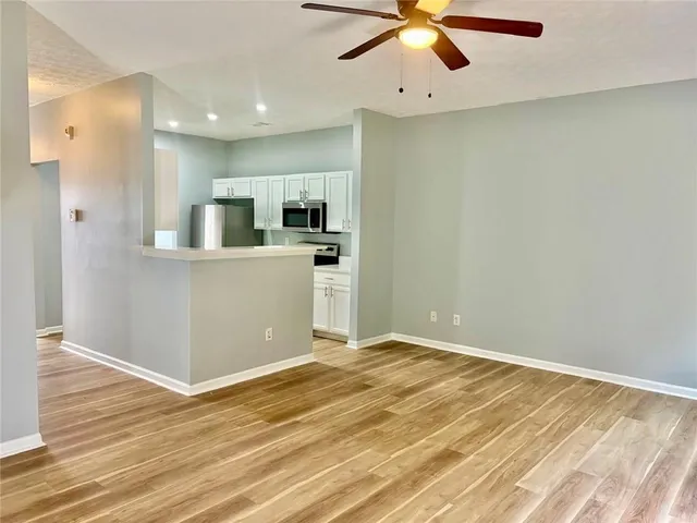a view of a kitchen with a sink and wooden floor