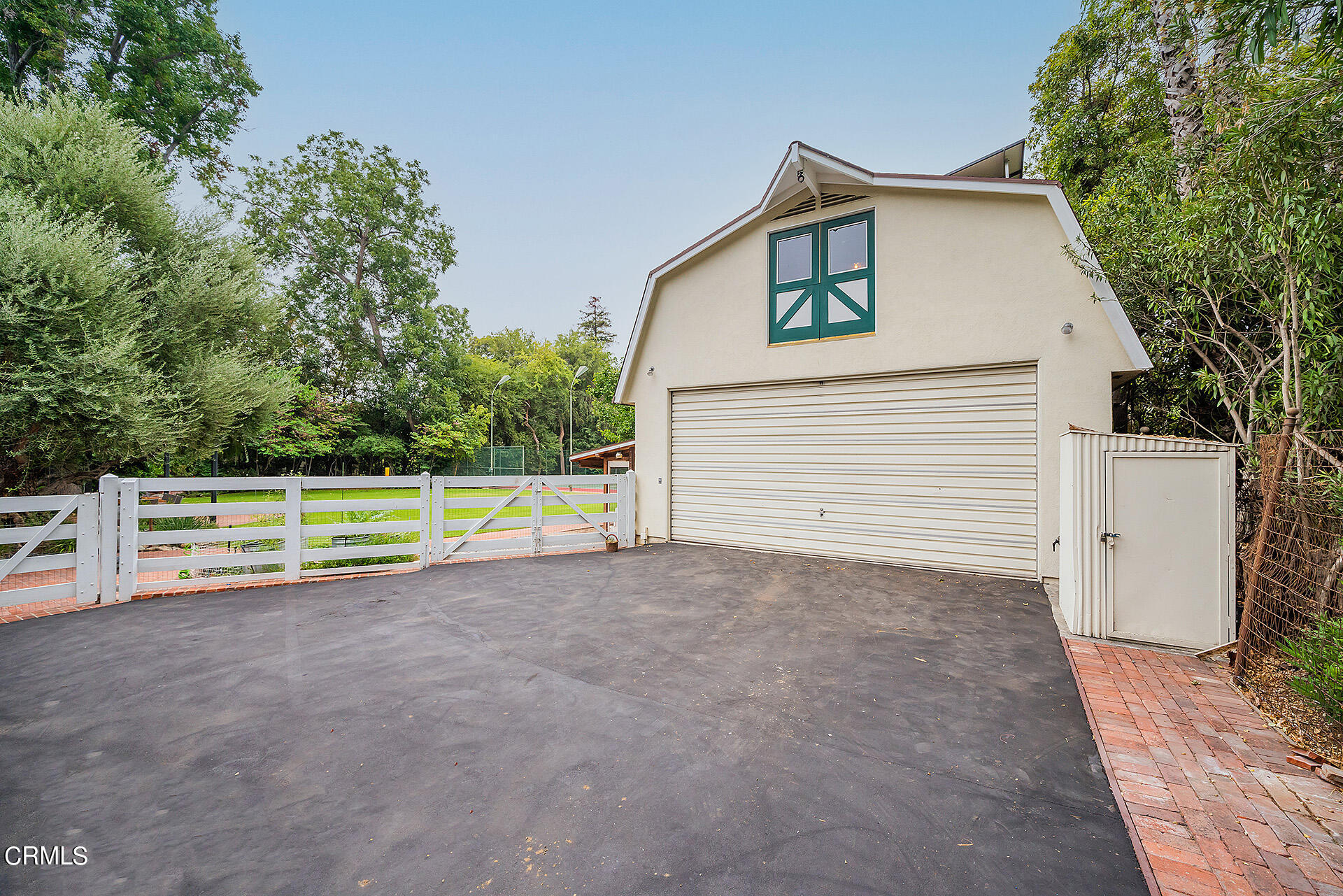 2035 South Oak Knoll Avenue San Marino, CA 91108 - Photo 26 of 28 a small white house with a small yard and large trees