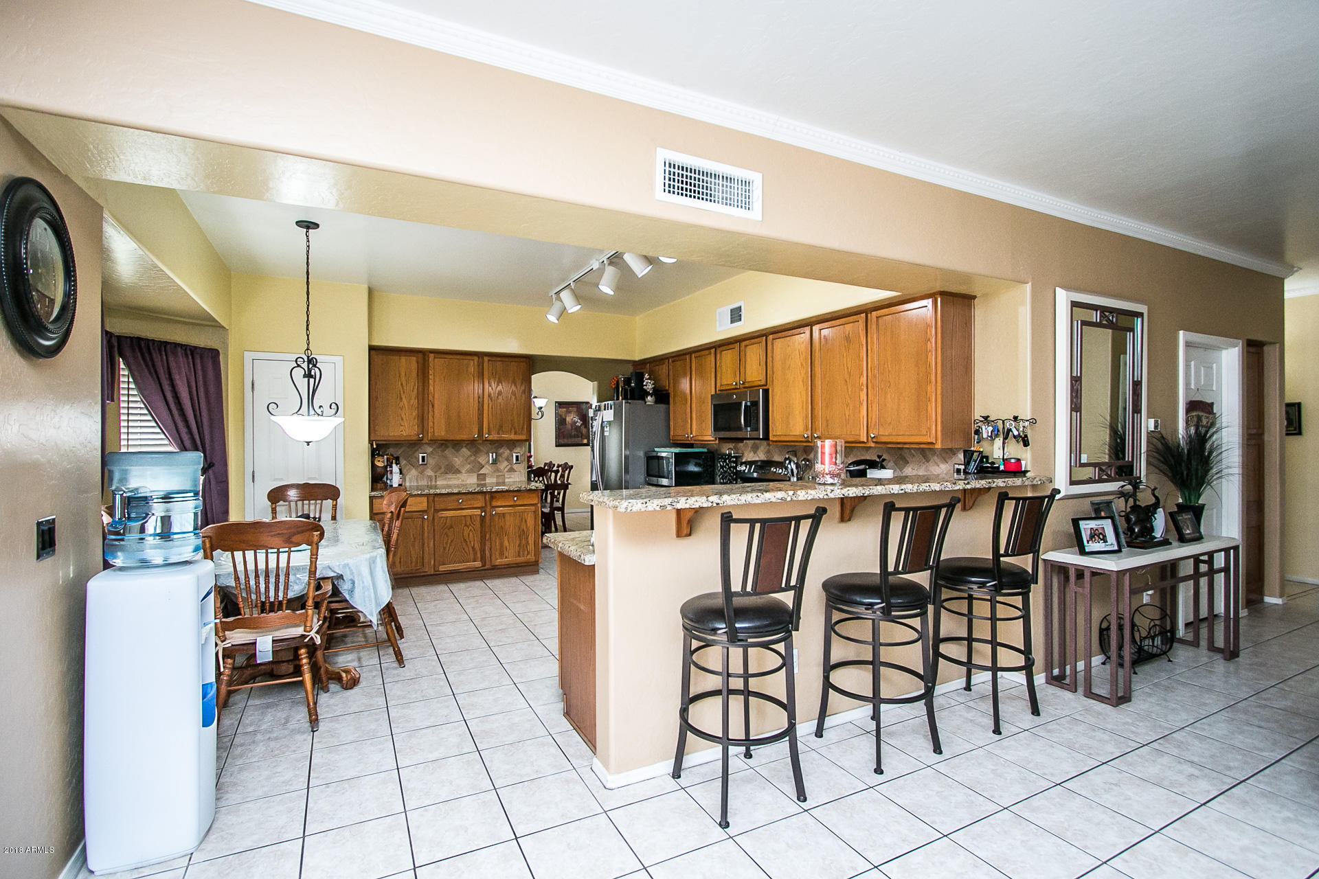 618 East Ranch Road Gilbert, AZ 85296 - Photo 11 of 32 a kitchen with cabinets and chairs