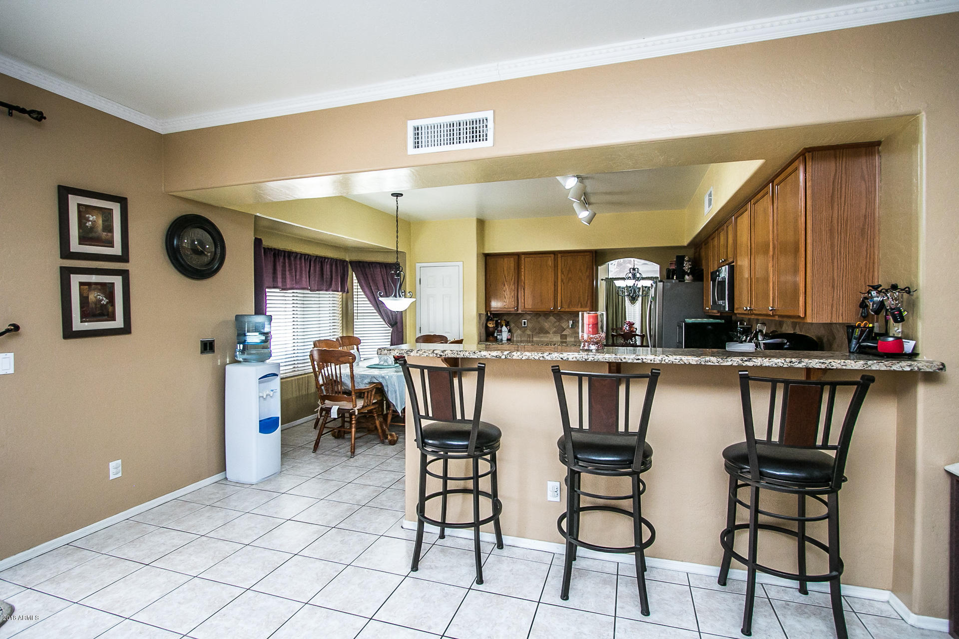 618 East Ranch Road Gilbert, AZ 85296 - Photo 12 of 32 a kitchen with a table and chairs in it
