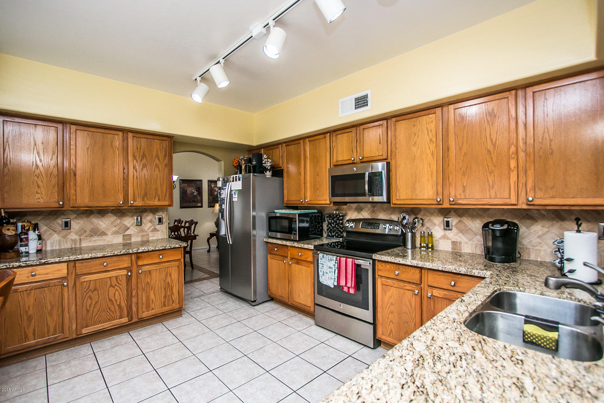618 East Ranch Road Gilbert, AZ 85296 - Photo 14 of 32 a kitchen with stainless steel appliances kitchen island granite countertop a sink and cabinets