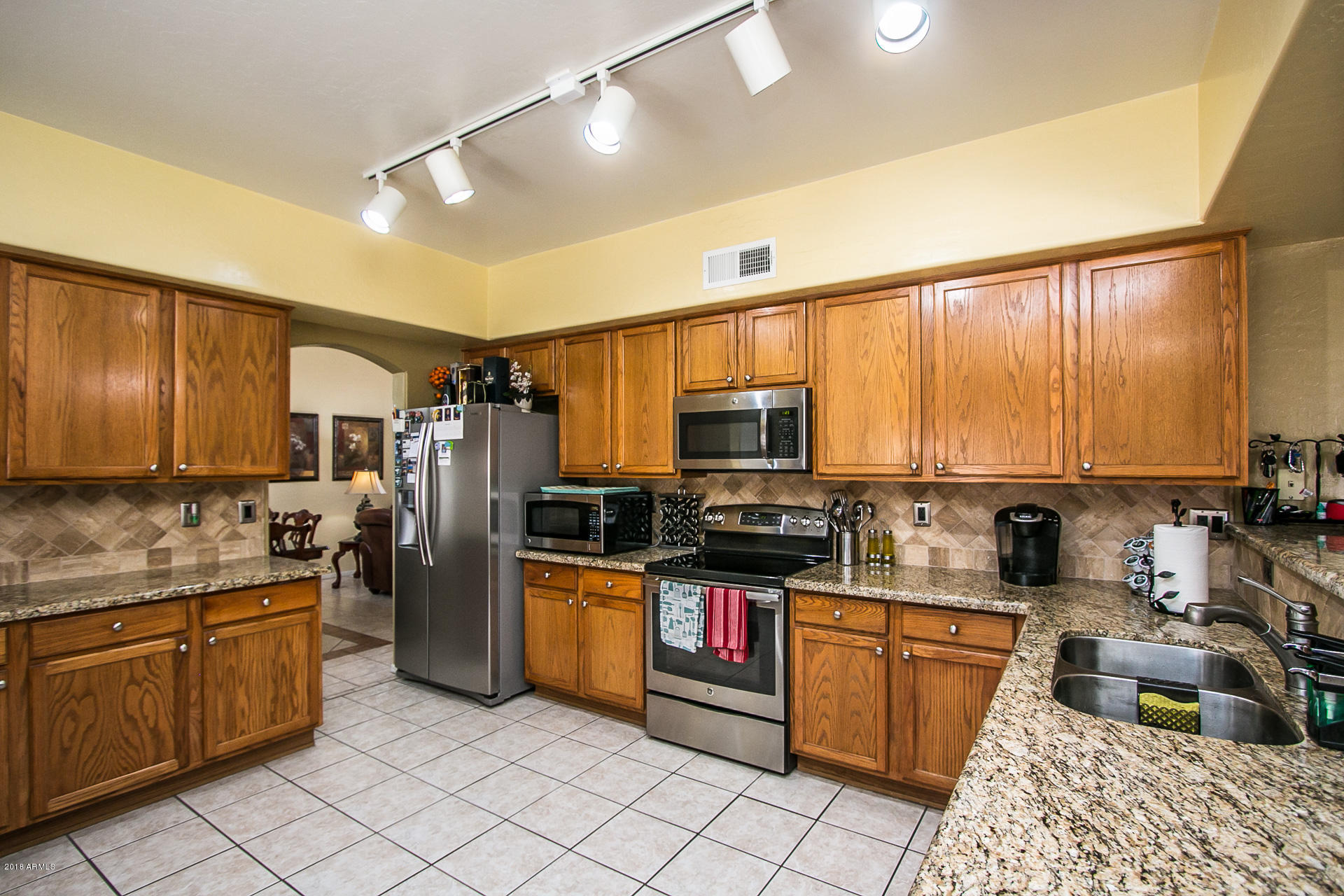 618 East Ranch Road Gilbert, AZ 85296 - Photo 17 of 32 a kitchen with stainless steel appliances a stove refrigerator sink and microwave