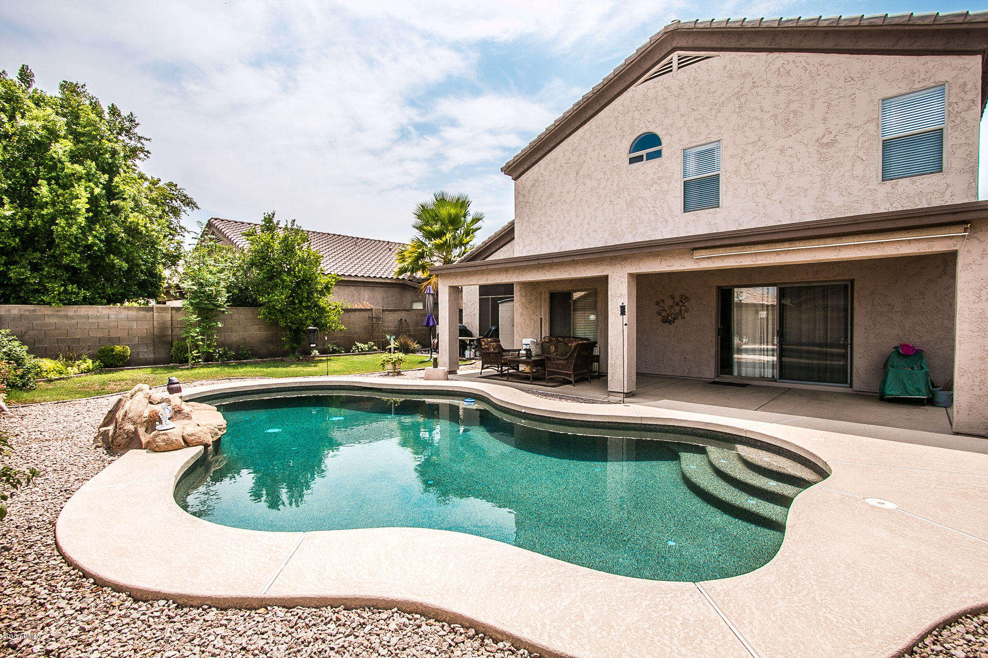 618 East Ranch Road Gilbert, AZ 85296 - Photo 31 of 32 a view of a house with swimming pool and sitting area