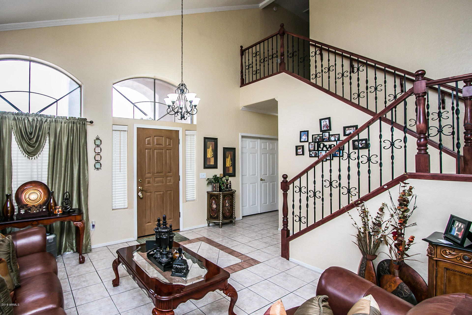 618 East Ranch Road Gilbert, AZ 85296 - Photo 6 of 32 a living room with wooden floor furniture and a chandelier