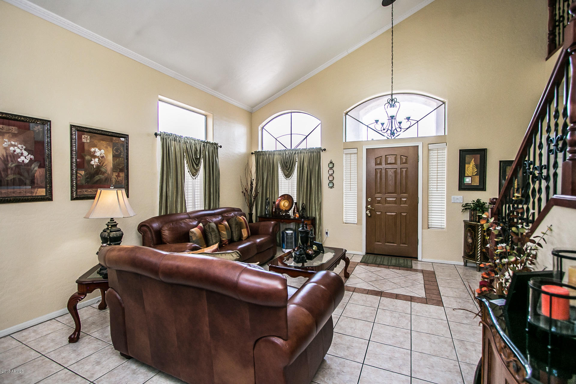 618 East Ranch Road Gilbert, AZ 85296 - Photo 7 of 32 a living room with furniture chandelier and a mirror