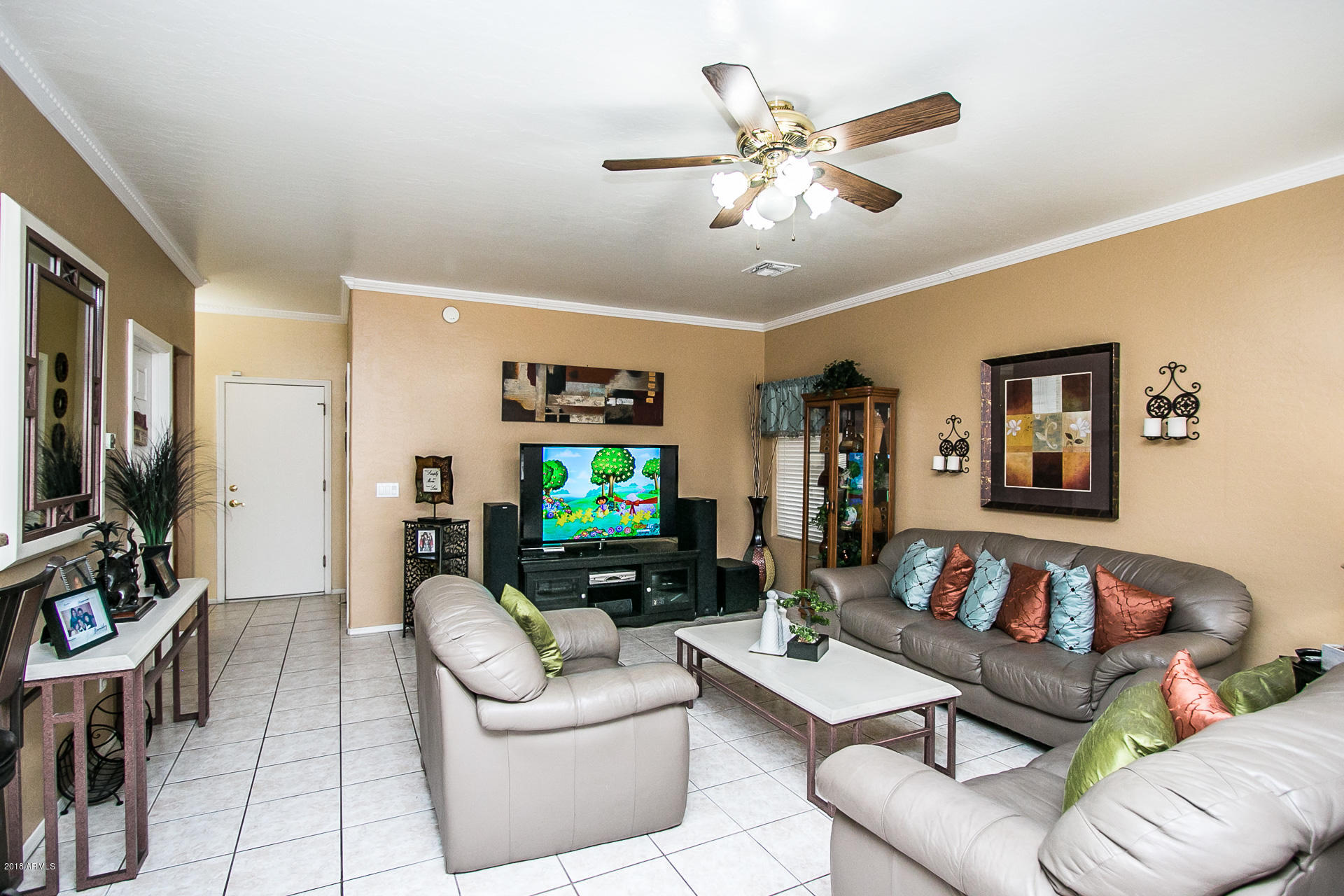 618 East Ranch Road Gilbert, AZ 85296 - Photo 9 of 32 a living room with furniture a ceiling fan and a window