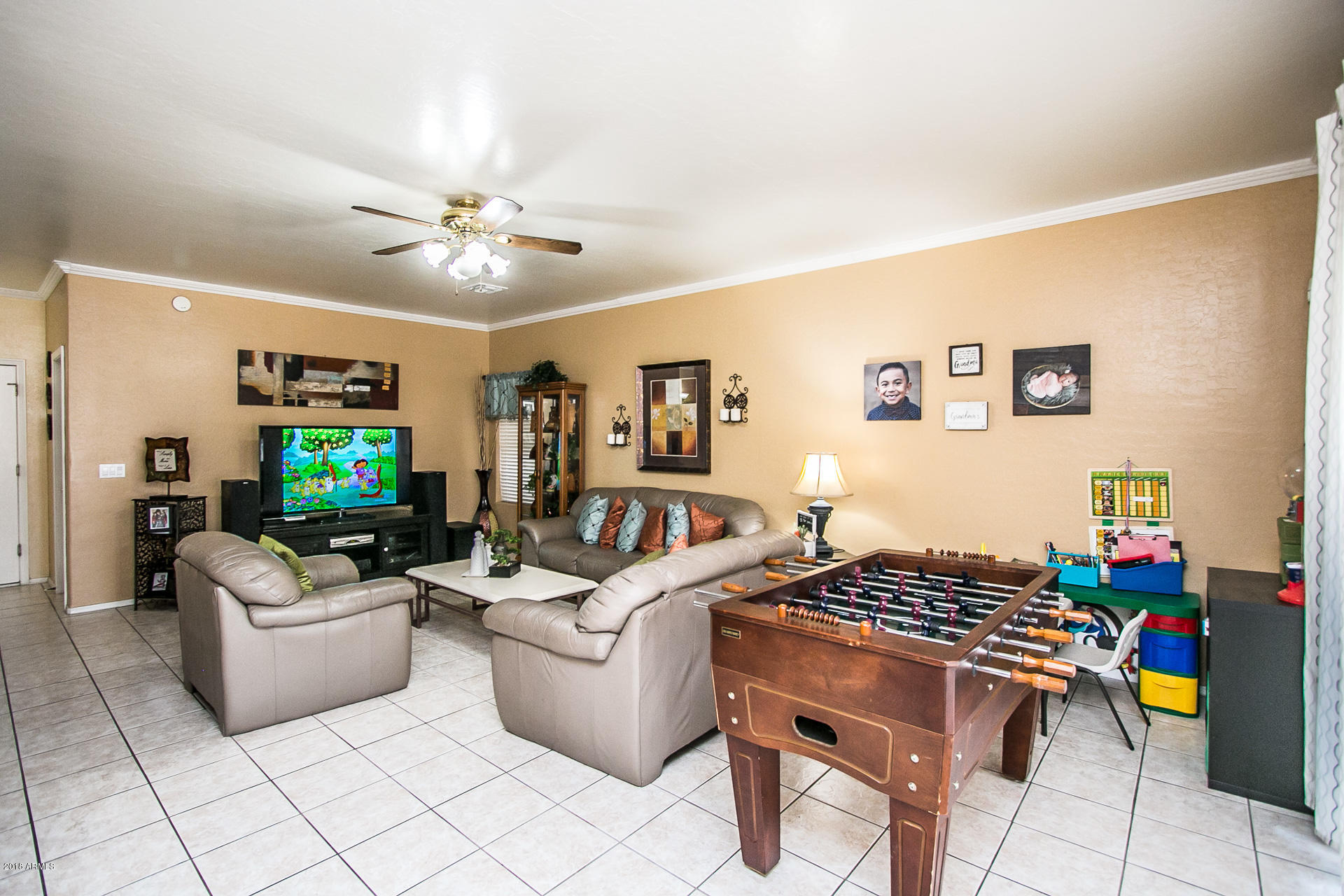 618 East Ranch Road Gilbert, AZ 85296 - Photo 10 of 32 a living room with furniture and a flat screen tv