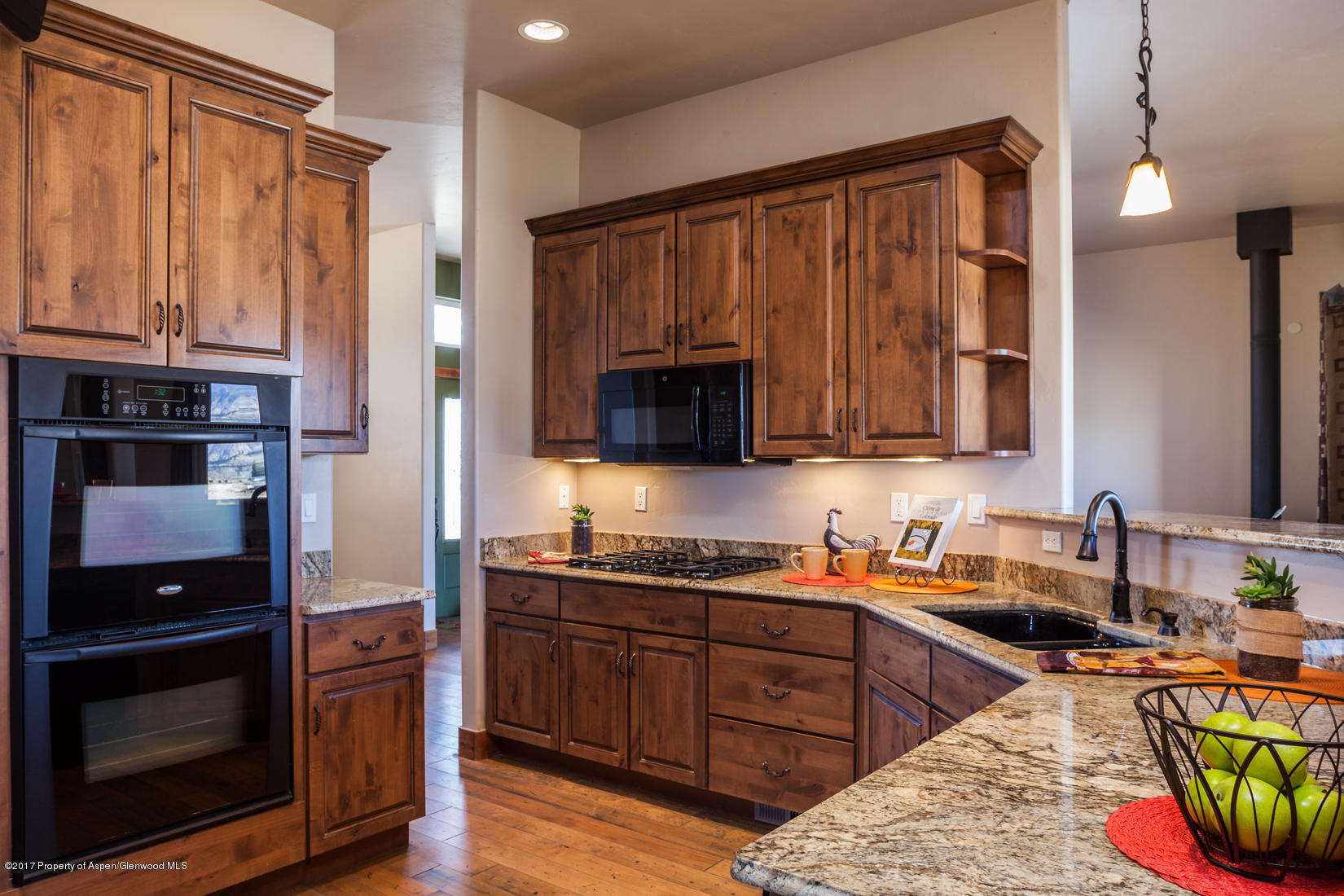 1312 Home Ranch Road Rifle, CO 81650 - Photo 4 of 22 a kitchen with stainless steel appliances granite countertop a stove a sink and a microwave