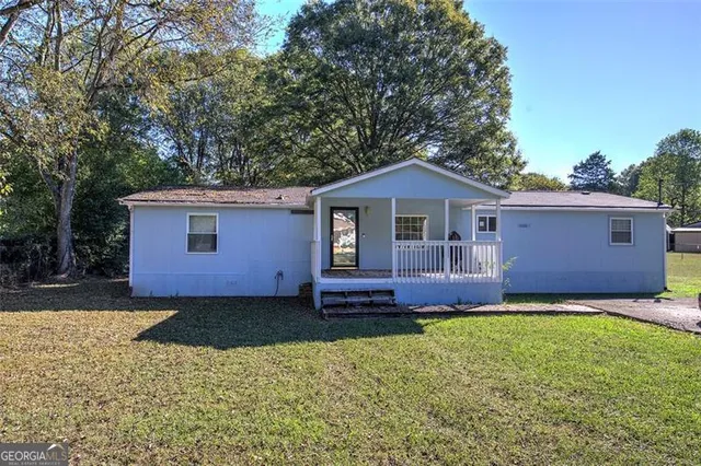 a front view of a house with garden