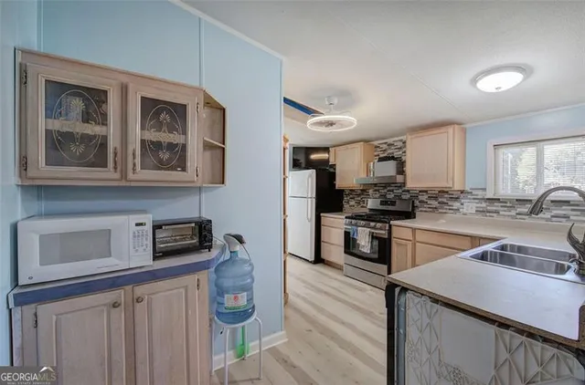 a kitchen with a refrigerator stove and sink